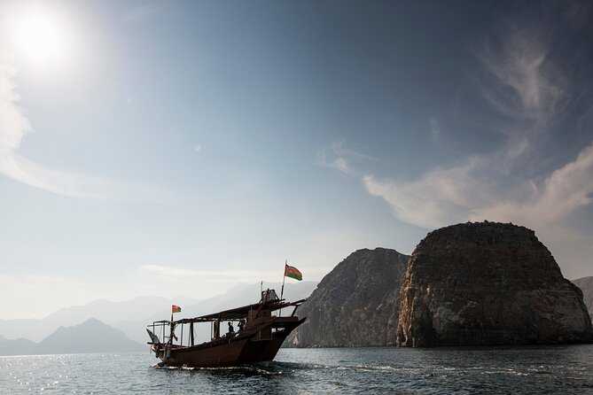 Overnight Dhow Cruise Khasab Musandam" typically involves a traditional dhow boat cruise in the Musandam region of Oman. This cruise offers a serene and picturesque experience, with passengers spending the night on the boat. Alt text for an image related to this experience might be: "A traditional dhow boat under a starry night sky in Khasab, Musandam, Oman, illuminated by soft onboard lighting