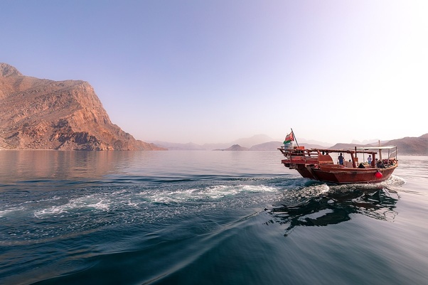 A mesmerizing view of Musandam Peninsula from the deck of our Khasab Dhow Cruise, capturing rugged cliffs, crystal-clear waters, and cultural wonders. Plan your adventure today!